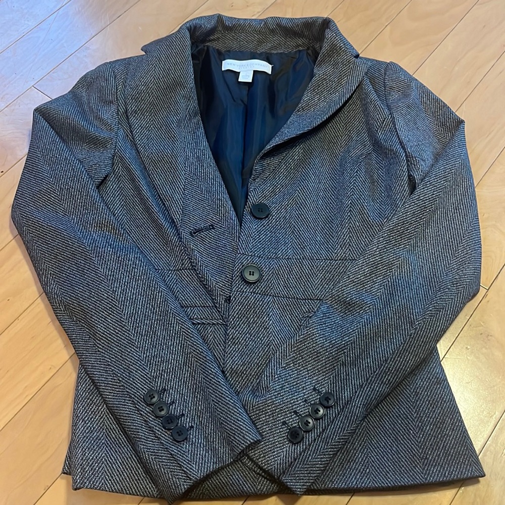 This is a New york and company grey, black, and white blazer size 0.